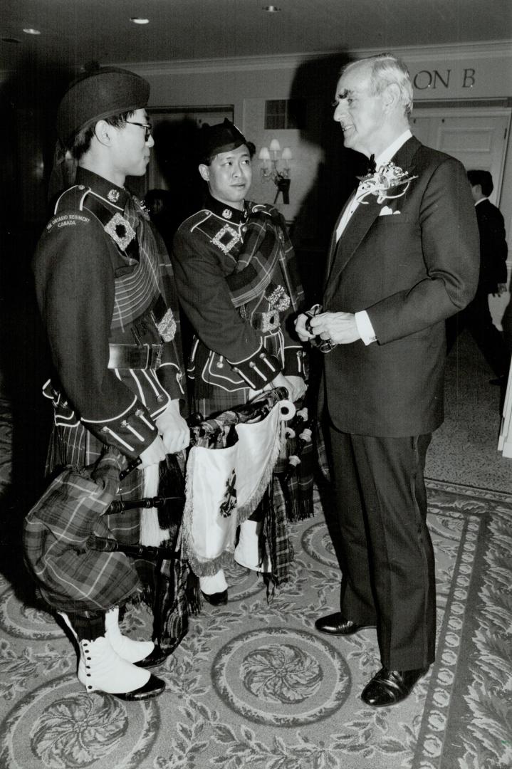 Piping in chinese new year, Lleutenant-Governor Hal Jackman meets Hilton Leung, left, and Marcus Lem who piped in the Year of the Monkey at yesterday'(...)