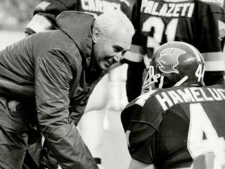 Team man: Dr. Robert Jackson: shown talking to Mike Hameluck: is on the field for every Argonaut game: home and away. He has been the team doctor since 1959