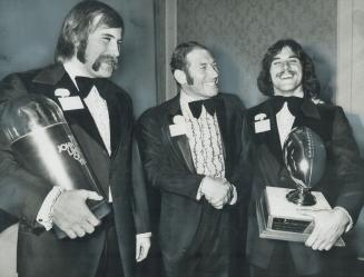 Best in Canada, Russ Jackson, Argos' coach-elect, congratulates Al Charuk of Acadia, named most valuable player in Canadian college football at Skylin(...)