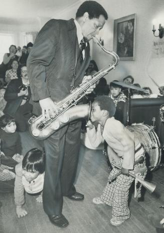 . . . And it comes out here! Jazz Illinois Jacquet entertained the children at Cecelia smile Nursery school on Oriole Rd. yesterday and Gary Barke, 5,(...)