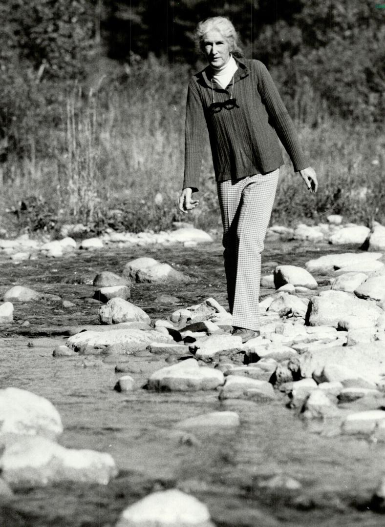 Environmental concerns, Lois James, secretary of Save the Rouge Valley System, strolls along the edge of the Rouge River near her home. Her group fears new housing will hurt the land