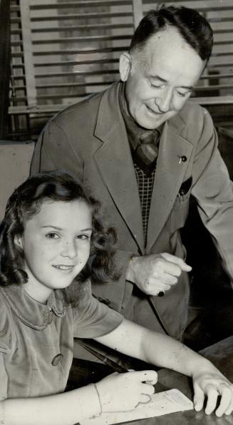 Happy girl makes others happy. Gloria Jean, charming 11-year-old singing screen star, is seen with Gregory Clark just as she was about to endorse a ch(...)