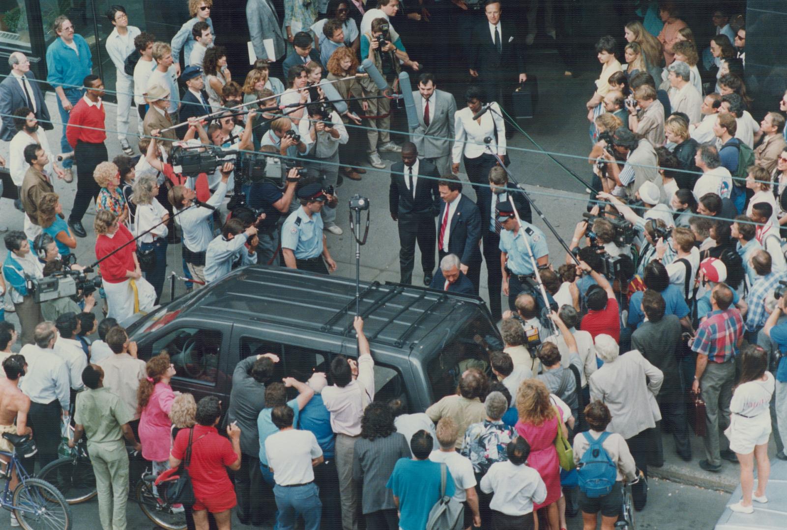 Media circus: Throngs of journalists from around the world surround Ben Johnson as he leaves the Dubin inquiry following testimony