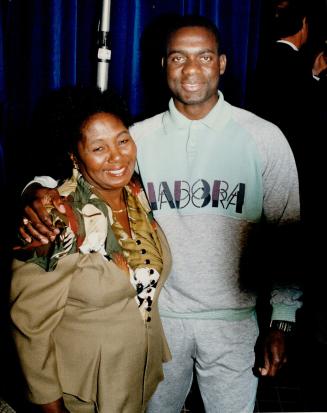 Smiling again: Ben Johnson and his mother, Gloria, look relaxed and happy at yesterday's news conference