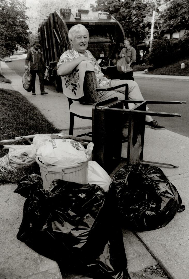 An Inveterate scavenger, Metro Councillor Anne Johnston poses with a chair and table she rescued from the trash