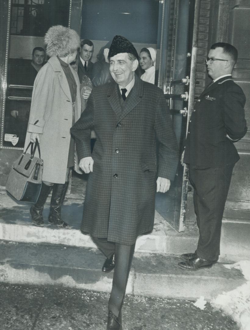 Home with his new heart. Heart transplant patient Charles Johnston walks jauntily out of St. Michael's Hospital yesterday as his wife, Margaret, waves(...)