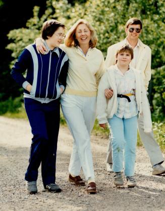 Just ordinary folks: The Johnston clan -- son Aaron, Lynn, daughter Katie and husband Rod -- take a stroll near their comfortable home in the small northern Ontario village of Corbeil