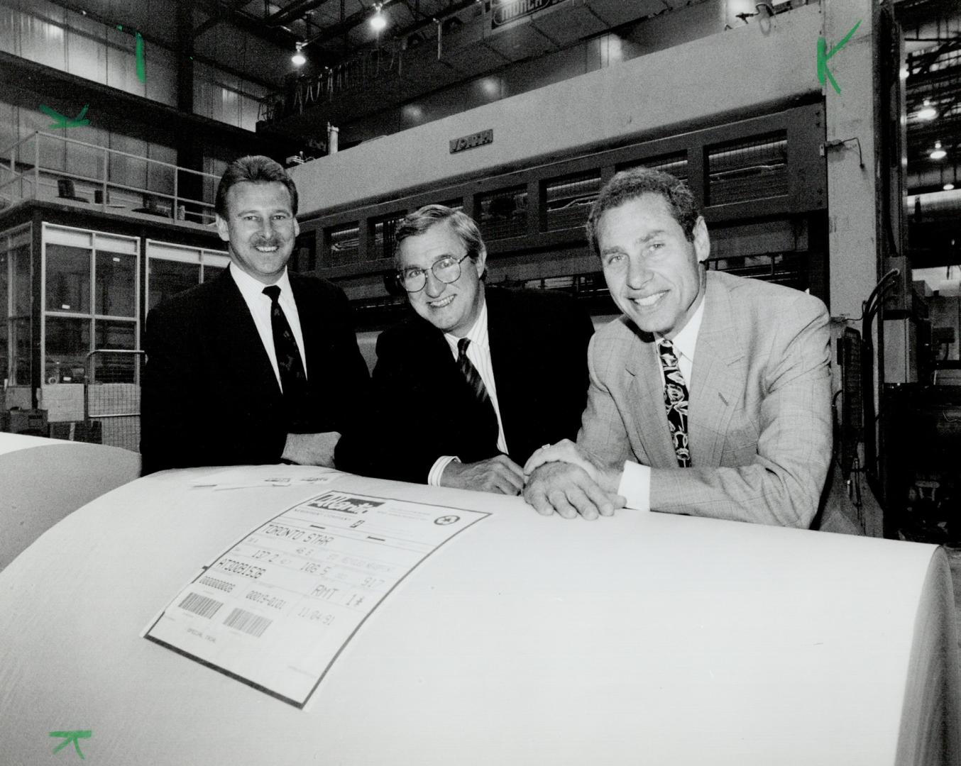 Ready to roll: Atlantic Packaging sales chief Michael Booth, left, Star publisher David Jolley and Atlantic president Irving Granovsky check shipment