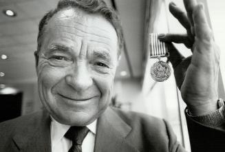 Medal of devotion: Developer Ignat Kaneff shows off the commemorative medal received from the federal government for his community service