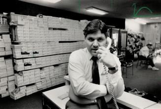 Karygiannis wraps up some last minute business at the family-owned shoe store on Danforth Ave