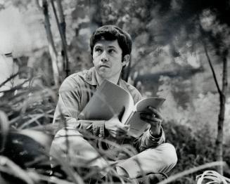 Moment of relaxation is enjoyed by Peter Kastner in the yard of the Kastner home in Forest Hill Village