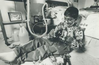 Azeem Kayum, 11, above, plays with his wrestling figures at home in Stouffville and, left, five years ago