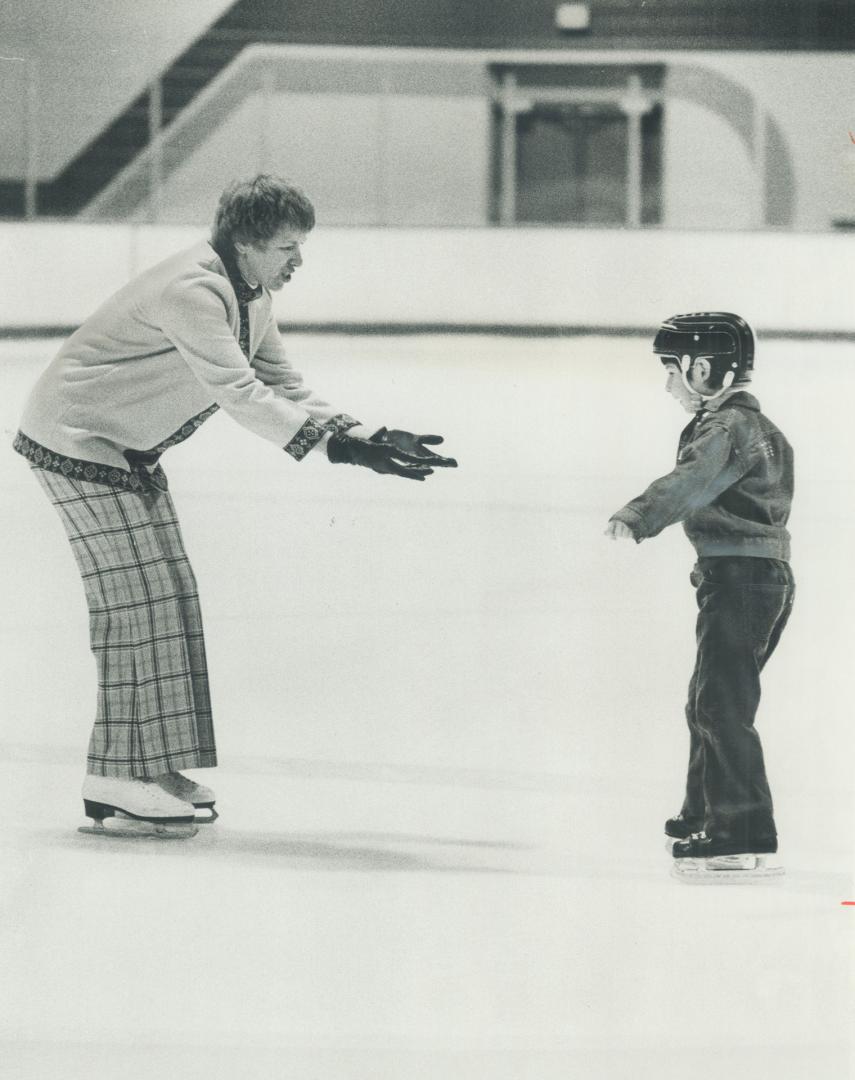 Teaching the blind to skate, Andra Kelly, wife of Leaf coach Red Kelly, coaxes 7-year-old Paul Legare (top) to try it