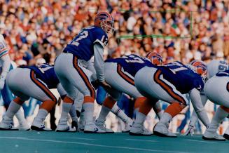 Bills boosters come in many shapes and sizes and under varying layers of clothing (at top), to cheer on quarterback Jim Kelly (above, taking a snap fr(...)