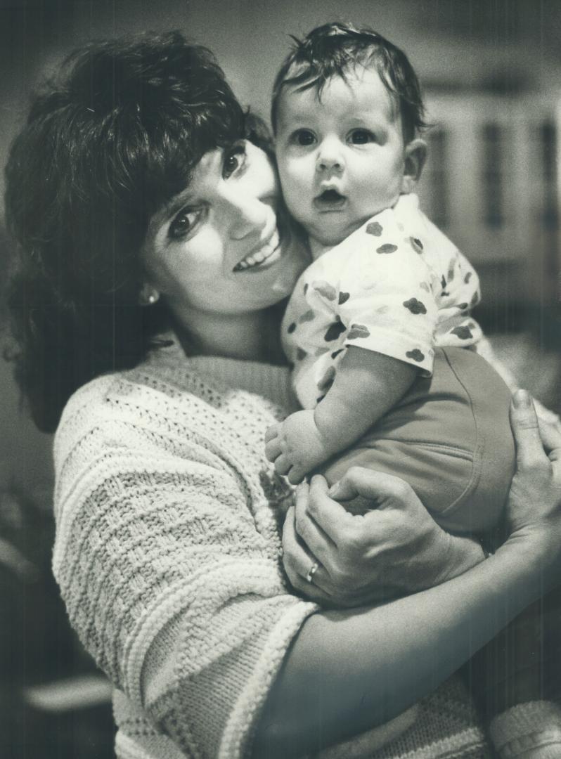 Maggie and son make debut. Margaret Kemper, ex-wife of former prime minister Pierre Trudeau, hugs her son, Kyle, 5 months old. She is married to Ottaw(...)