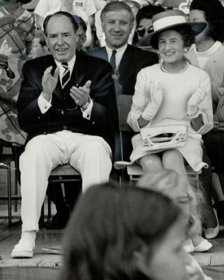 Mrs. Rose Kennedy applauds parade at special olympic games in CNE stadium. At left is Harry (Red) Foster