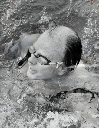 Keeping part of a promise he made five years ago, Solicitor-General George Kenr swims (left) in the murky waters of Burlington Bay Saturday, but he ad(...)