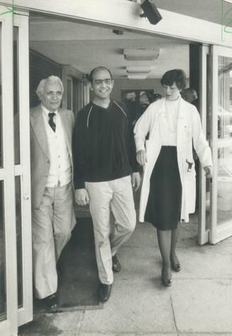 Predicting he will live to be the longest-living person with a transplanted heart, 37-year-old Tayeb Khan (middle) walks out of Toronto Western Hospit(...)