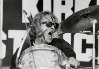 Percussive portraits: Graeme Kirkland in beaten-face photo used on Sleep Alone and in warpaint for a clock destruction this week at Nathan Phillips Square