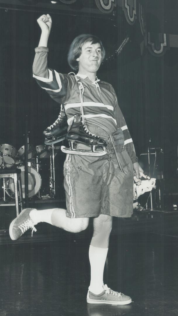 Tom shows kneebone. Hockey non-great Tom Kneebone hams it up at the Royal York Hotel at a lunchtime fashion show to promote the Toronto Symphony's rum(...)