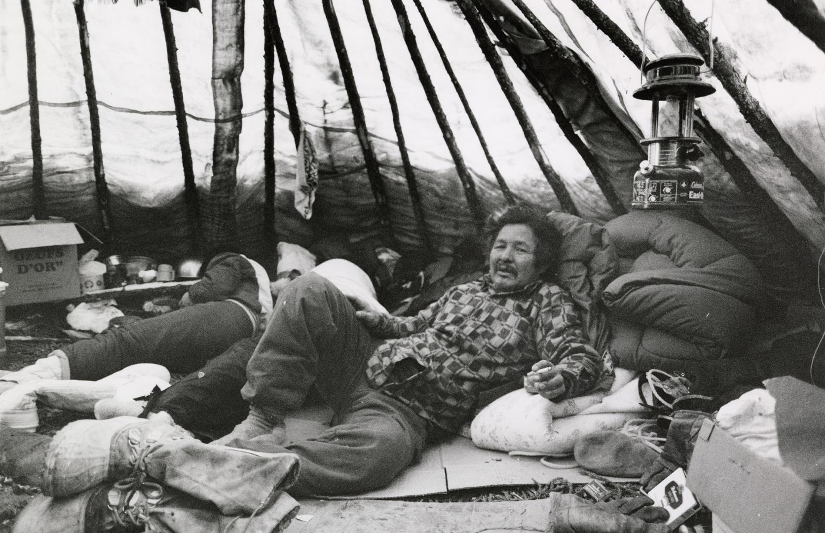 William Kawepit and family use tent in an isolated area as an occasional refuge from village life