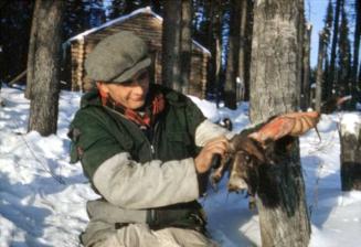 Elijah Baxter pelting a marten, Wishi Lake, December 1951