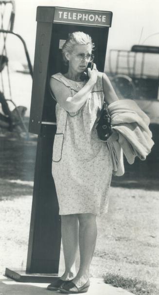 The other world: Wylie in phone booth making her daily contact with the world outside her life in a boarding house