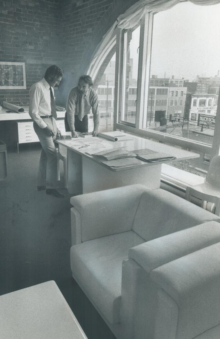 Architects Eberhard Zeidler and Bill Strong work in their office in a converted warehouse on Queen St