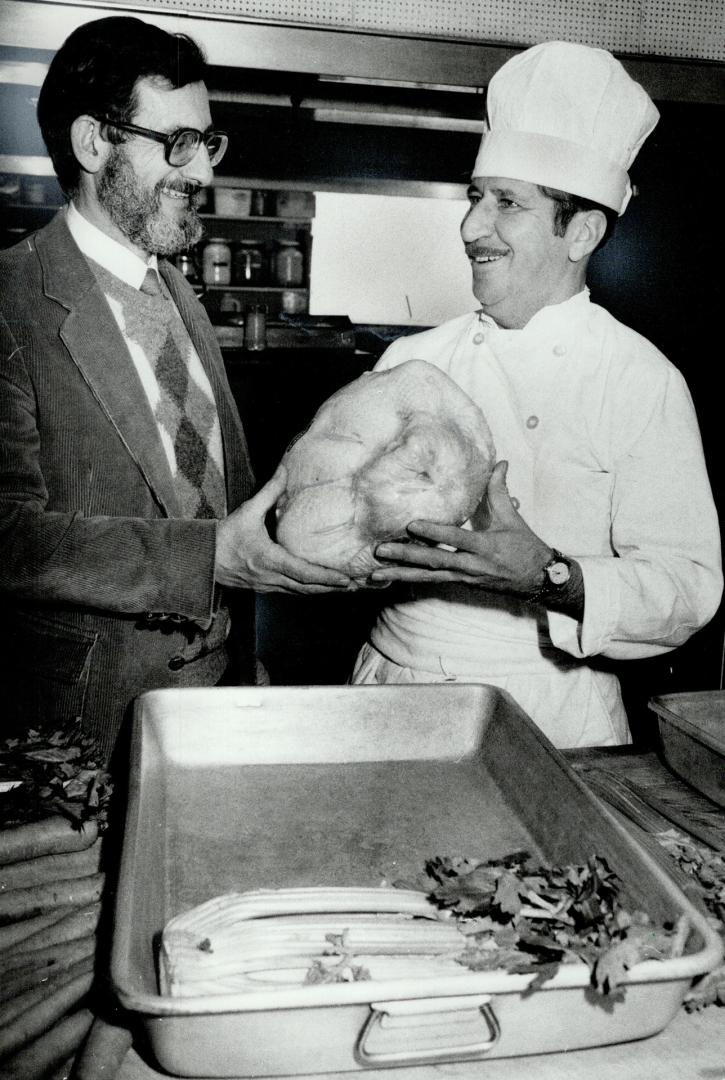 1 down, 3,349 to go: Rev. Alex Zeidman (left) and chef Gerard Petit make plans for the Scott Mission's first Christmas turkey