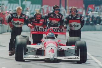 End of the line: Canadian Paul Tracy's crew pushes him off the track and out of the Molson Indy yesterday, a victim of a faulty gearbox