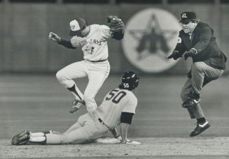 Got him! Blue Jay second baseman Garth Iorg steps gingerly over Boston rookie Rick Gedman who is being unceremoniously signalled out by umpire Durwood(...)