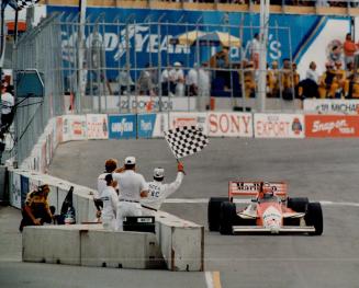 The checkered flag comes down as veteran Brazilian driver Emerson Fittipaldi wins the second Molson Indy race yesterday at Exhibition Place