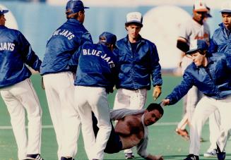 The Blue Jays ground crew had to clear the field in the late innings, but this tidying up job was for an overexuberant fan who raced on to the field