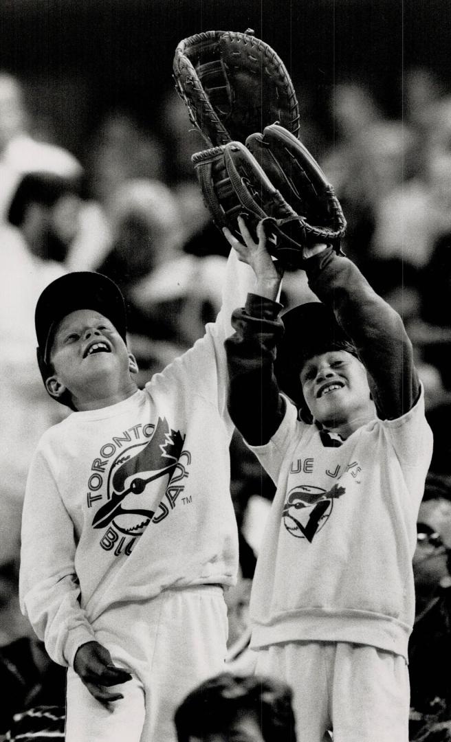 Michael, 10, and Stephen Andrews, 8, show they're part of the team that's hoping, praying, cheering for the Blue Jays to bring home the pennant. Jays beat Cleveland 5-2