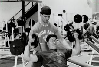 Blue Jay brother act: Pitcher Mike O'Halloran spots for his brother, catcher Greg, as they work out in prepartion for season