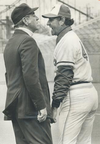 Jays' 3rd base coach Harry Warner jaws at umpire George Maloney