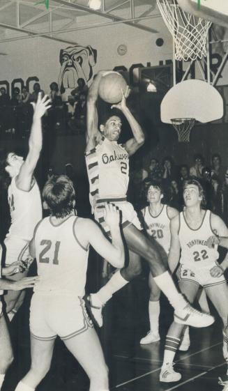 Up and away: Oakwood's Norman Clarke (2) outjumps Runnymede's Ralph Salvino (21), Bo Lisik (20) and Dan Stobberman (22) in Barons' 86-80 win over the Redmen in Metro final last night