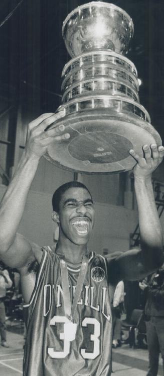 Hardward Hoist: O'Nelli guard Doug Wilson raises the OFSAA Ontario championship trophy after his side's 64-56 win over Runnymede Redmen