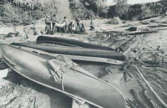 Canoeists prepare to set up their camp by the side of one of the countless streams available for excursions in Ontario