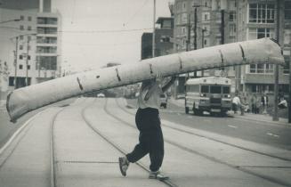 Now that's a portage. Jennifer Walker from the Harbourfront Canoe School carries a 15-foot birchbank canoe across Queen's Quay yesterday. The canoes a(...)