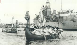 Dragon heads mounted on prows got the spirit - if not the canoes - moving in the first annual Dragon Boat Races yestedday in Haida Basin at Ontario Pl(...)