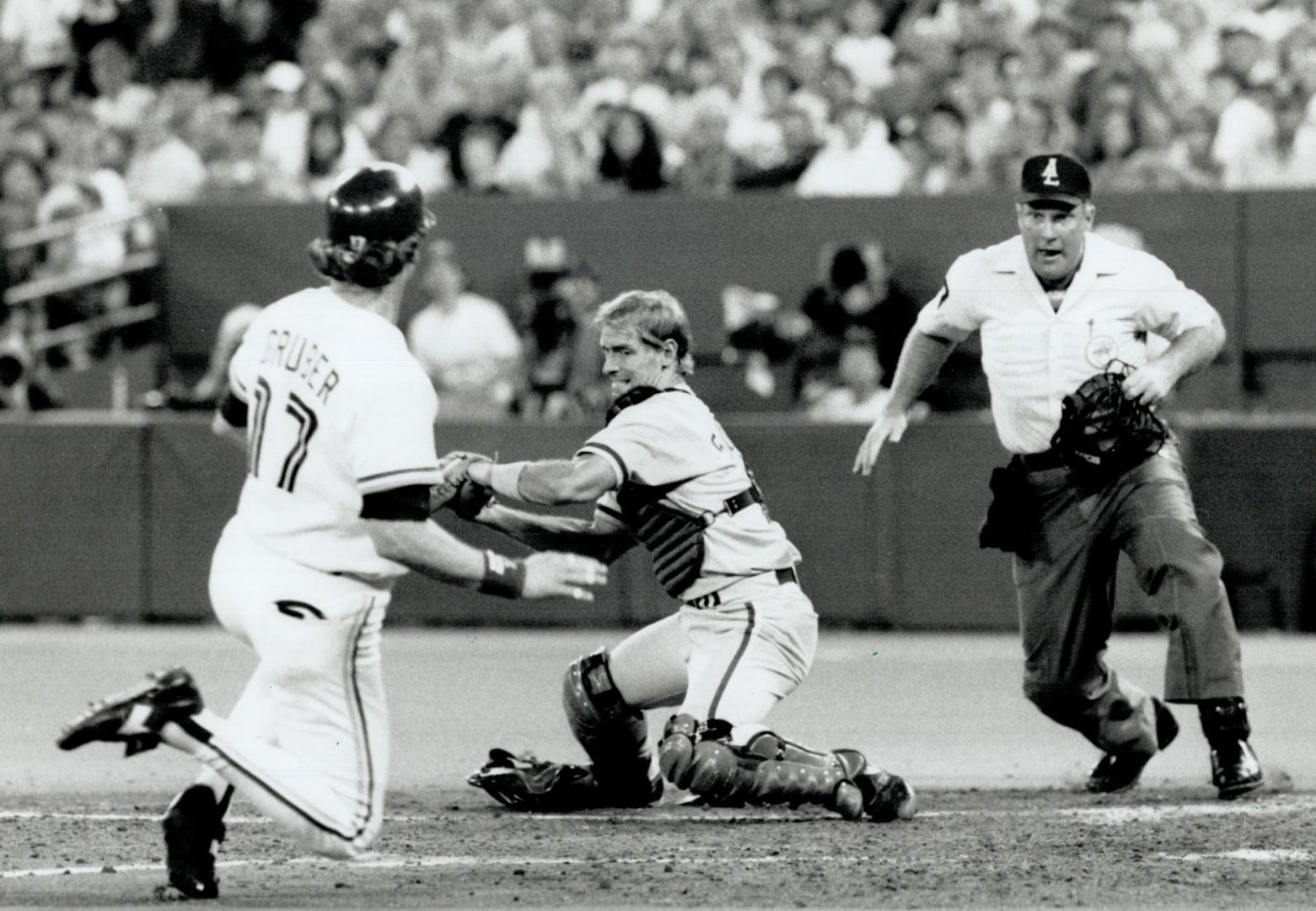 Close call: Brewer B.J. Surhoff takes the throw as Kelly Gruber slides home . .