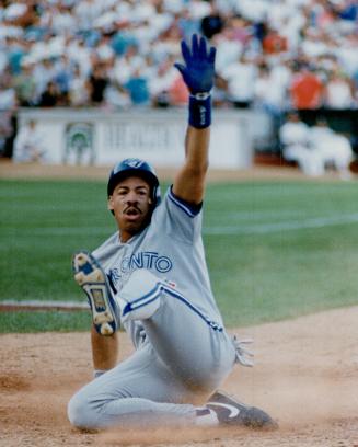 Derek Bell slides into third in the 11th and, one out later, scored the winning run