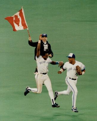 Flag-waving fan rushes on to field to join manuel Lee, left, and Candy maldanado in celebration