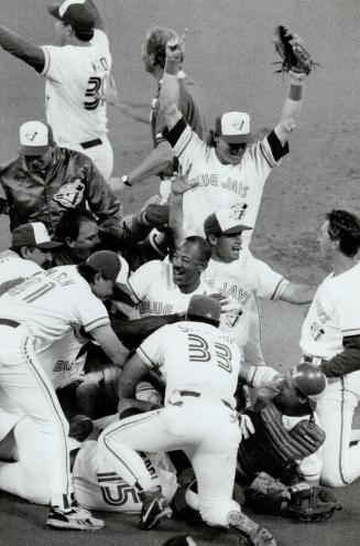 Party time! Somewhere under the pile of Blue Jays is Candy Maldonado, who got the last out of the game with a catch of Ruben Sierra's fly ball to left(...)