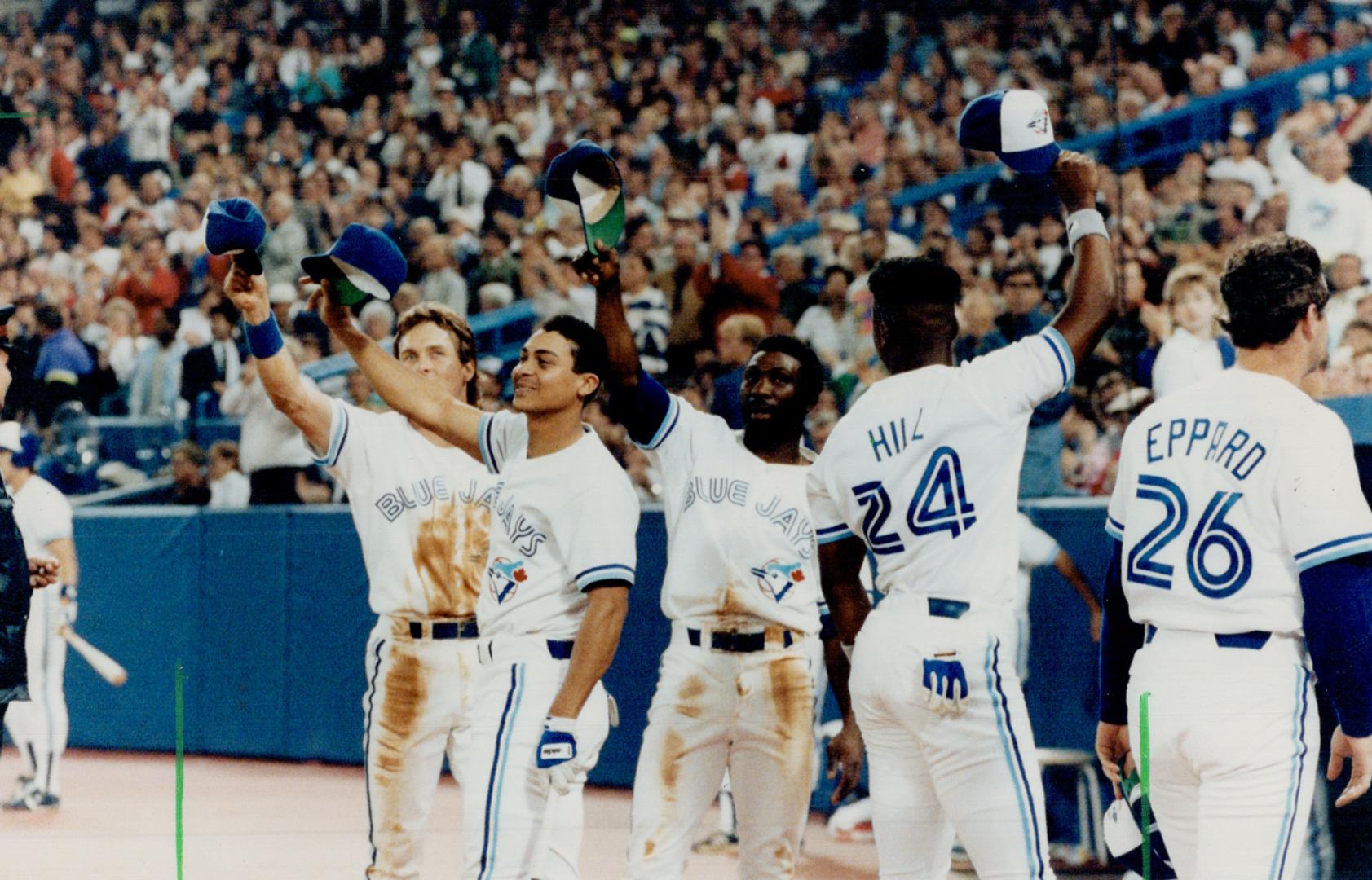 Hats off: Blue Jays Kelly Gruber, Junior Felix, Mookie Wilson and Glenalien Hill tip their caps to fans last night as a major league attendance record of 3,635,829 was set