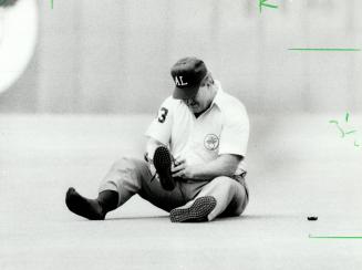 American League umpire Durwood Merrill decided to take a quiet moment between innings at yesterday's Blue Jays-Milwaukee Brewers game to sit on the turf and adjust his shoe