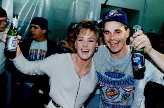 Winning pitcher Jimmy key celebrates with Ed Sprague's wife, Babb