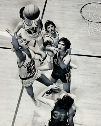 Brian Skyvington (52) fo Varsity Blues shoots for basket over Ryerson Rams' Dave Fogolin (45)