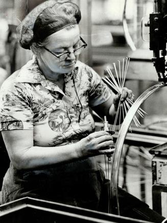 Lacing wheel hubs and rims is the principal job of Mary Mcillvany, one of company's 300 employees